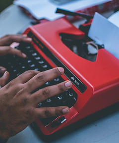 black-hands-red-typewriter